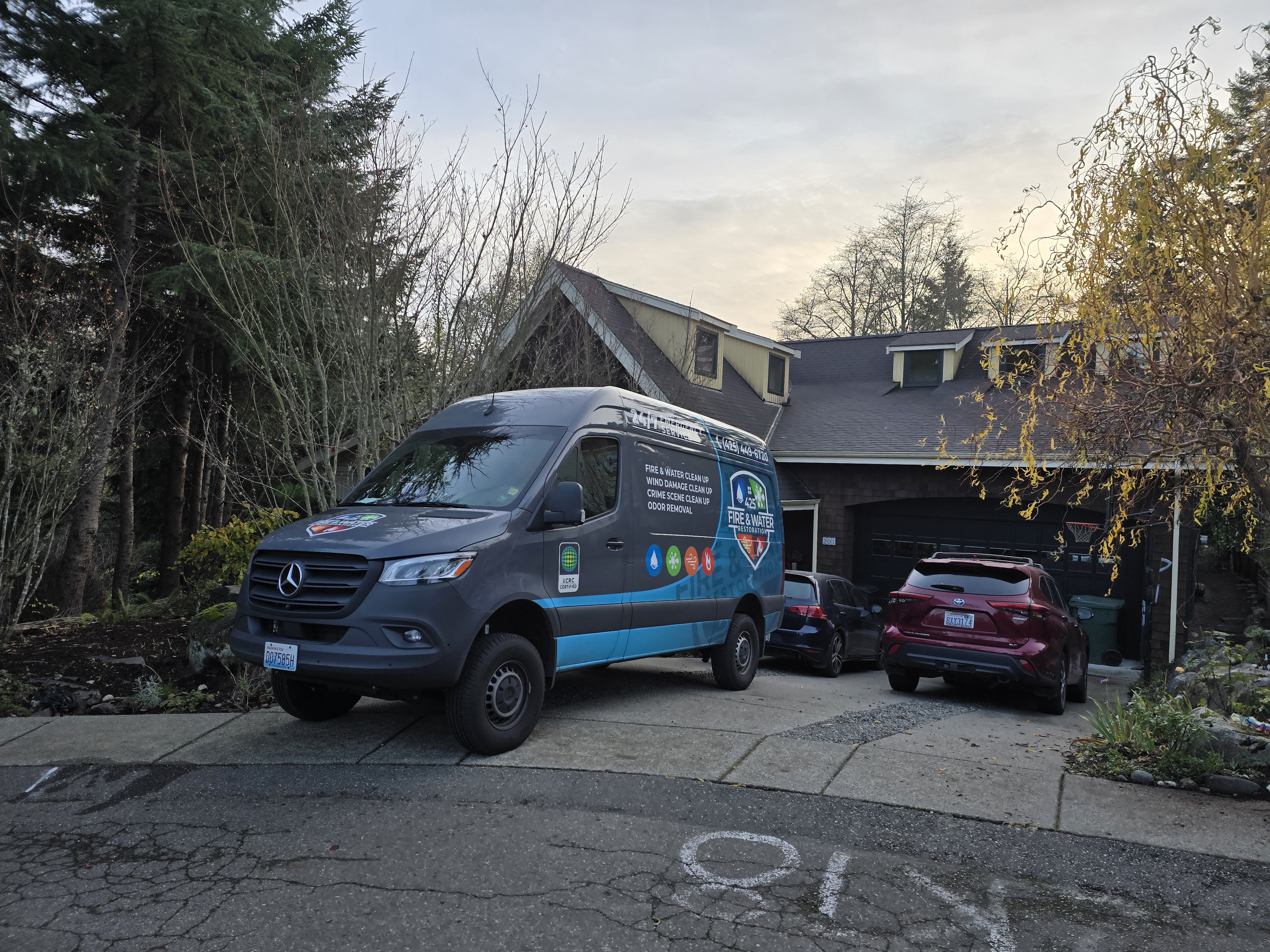 425 Fire & Water Restoration branded Mercedes Sprinter van on-site at a King County residential water damage job